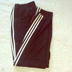 Black Adidas tear-away track pants.